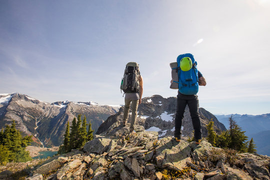 Two mountaineers look at their objective, Douglas Peak, B.C., Canada.
