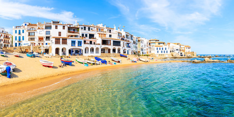 CALELLA DE PALAFRUGELL, SPAIN - JUN 6, 2019: Panorama of amazing beach in scenic fishing village with white houses and sandy beach with clear blue water, Costa Brava, Catalonia, Spain.
