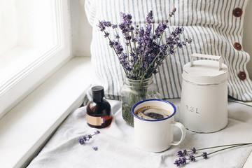 French summer still life. Cup of coffee, lavender flowers bouquet, essence oil bottle on...