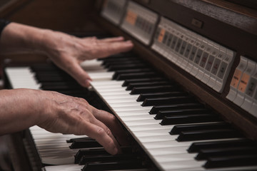 Fototapeta na wymiar Close up view of a organist playing an organ