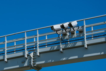Three cameras on a metal construction.  Industrial supervision. Motorway, highway speed cameras. 