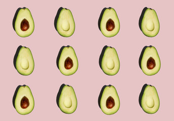 Fresh avocado pattern isolated on pink background.