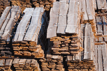 Wooden boards stacked in piles.
