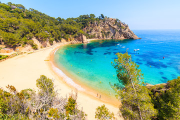 Couple of people on Cala Giverola, most beautiful beach on Costa Brava, Spain