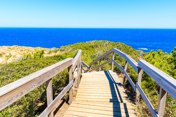 Fototapeta na wymiar Coastal wooden walkway to sea near Sa Tuna village, Costa Brava, Spain