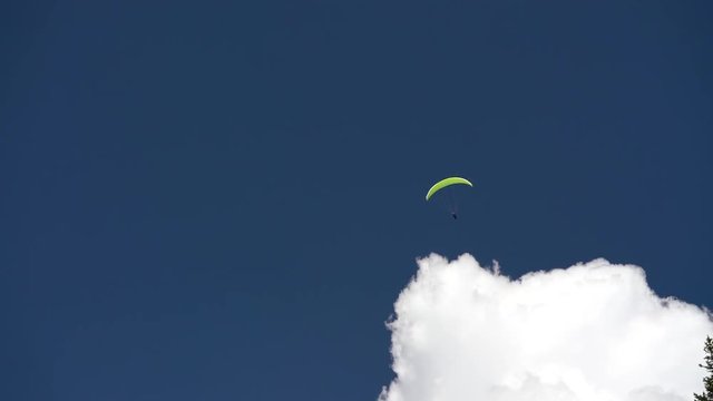 Man paragliding in a blue sky