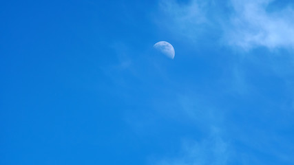 moon on a blue sky day