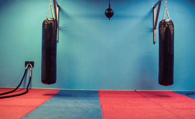 Boxing and fitness hall with battle rope,two boxing bag and weight on floor