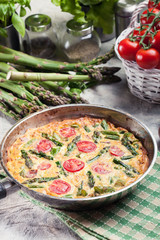 Frittata made of eggs, asparagus and tomatoes