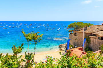 Fototapeta premium Amazing beach in Calella de Palafrugell, scenic fishing village with white houses and sandy beach with clear blue water, Costa Brava, Catalonia, Spain