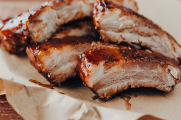 Closeup of pork ribs grilled with BBQ sauce and caramelized in honey. 