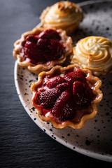 Fruit muffins, baked cookies with raspberries and cream