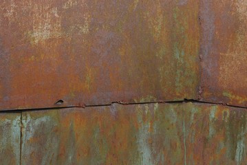 metal texture of rusty iron on an old wall with a seam