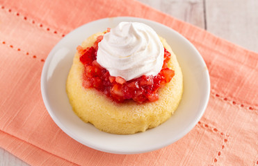 A Single Serve Strawberry Shortcakes with Strawberry Sauce and Whipped Cream