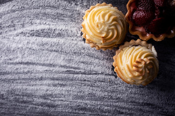 Fototapeta na wymiar Sweet dessert, creamy muffins on a flour background.