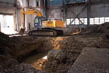Crawler excavator for demolition work. Dismantling of an old industrial building.