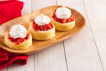 A Single Serve Strawberry Shortcakes with Strawberry Sauce and Whipped Cream