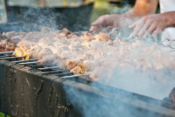 Slice pieces of meat on the grill. barbecue at the festival. Cheese and roasted veal on skewers.