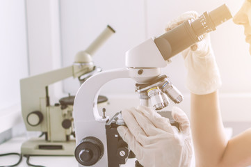 Hands with microscope in the laboratory
