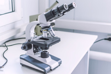 Hands with microscope in the laboratory
