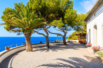 Palm trees on lighthouse terrace and sea view in Tossa de Mar town, Costa Brava, Spain