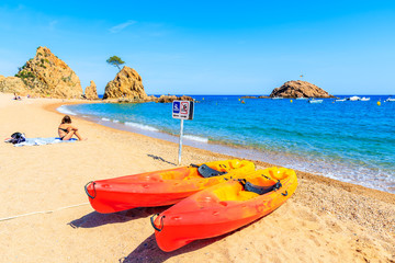 Colorful kayaks on beautiful beach in Tossa de Mar town, Costa Brava, Spain