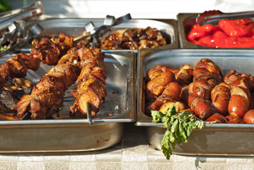 Different types of fried meat on the table. BBQ at the festival.
