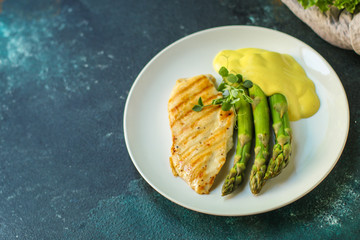asparagus and chicken grill meat, hollandaise sauce. food background. top