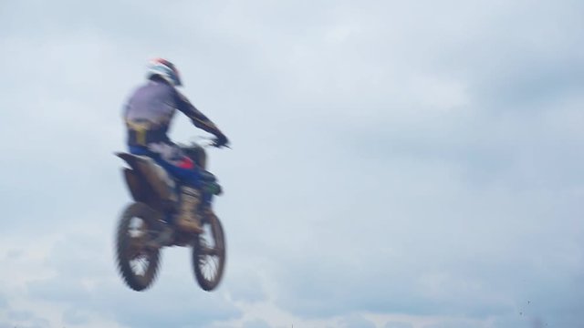 Motocross riders overcome the jump in slow motion. Jumping on a springboard.1920X1080 Full Hd.