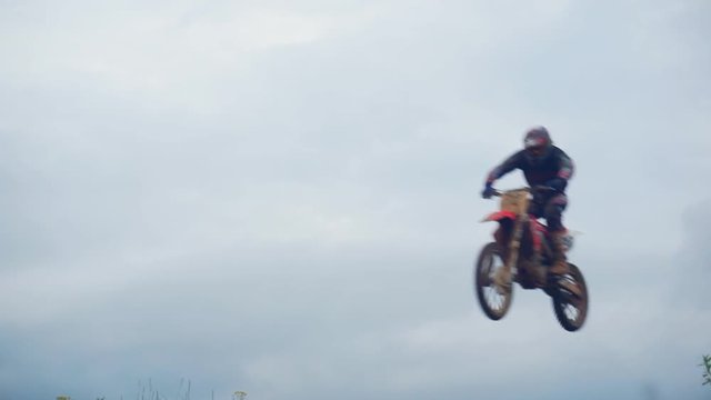 Motocross riders overcome the jump in slow motion. Jumping on a springboard.1920X1080 Full Hd.