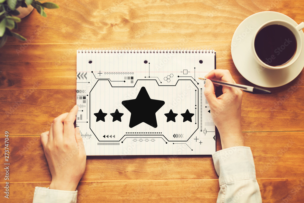 Poster five star rating with a person writing in a notebook on a wooden table