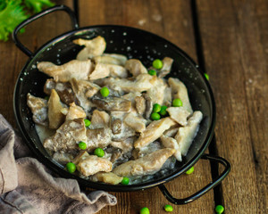 chicken meat with mushrooms in a creamy sauce - snacks. healthy food and menu. copy space