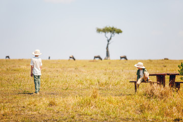 Naklejka na ściany i meble Kids witnessing great migration in Kenya