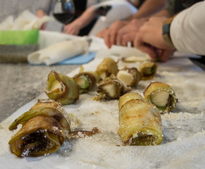 Close up of authentic italian eggplant parmesan drying on paper towel at italian cooking class
