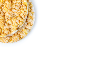 Caramelized corn cakes. Puffed whole grain crispbread isolated on white background. Close-up.