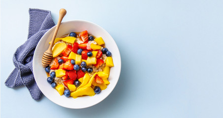 Homemade porridge served with fruits and berries