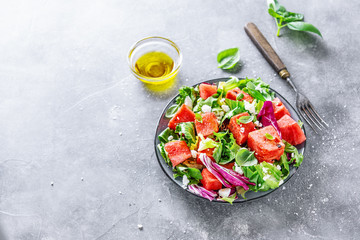 Fototapeta na wymiar Summer salad with watermelon and salad leaves