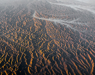 Aerial View from an Airplane. Flying above Beautiful Land at Sunrise.