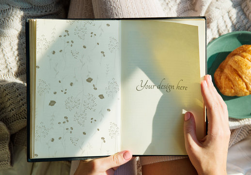 Person Holding a Book Mockup