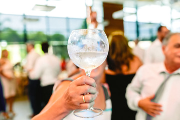 Woman holding a glass of fresh drink during an event.
