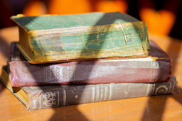 Old ancient historical retro books on the table in the gazebo