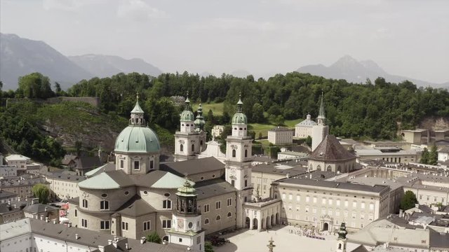 The Mozartplatz in Salzburg on a sunny day with the sourrounding old architecture including the Salzburg Museum, the cathedral, the Residence the Franziskanerkirche. 