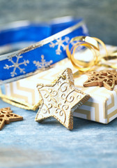 Christmas star, baubles and Christmas present. Christmas decoration. Wooden background. Close up. 
