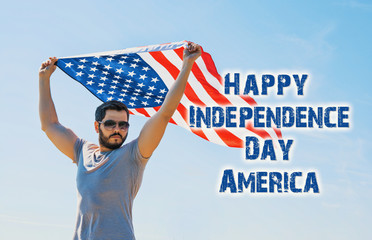 Happy Independence Day America! young man proudly hold waving american USA flag.