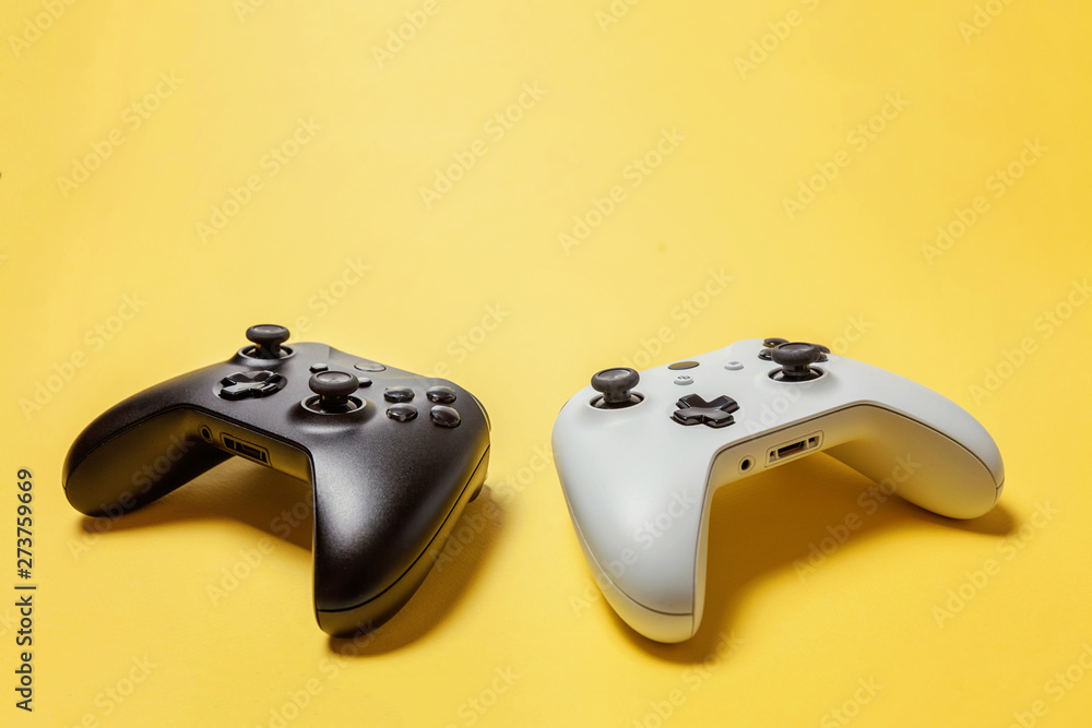 Wall mural white and black two joystick gamepad, game console on yellow colourful trendy modern fashion pin-up 