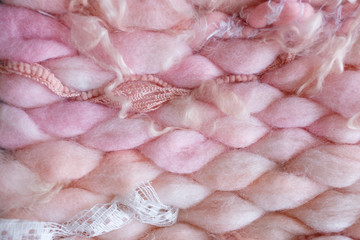 Texture of pink big knit blanket. Large knitting. Plaid merino wool. Top view