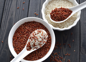 red and steamed rice mix in a ceramic bowls and spoons