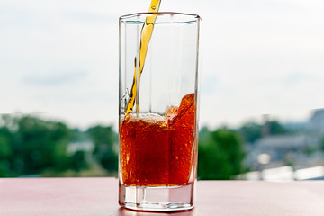Glass with a drink of Burgundy color