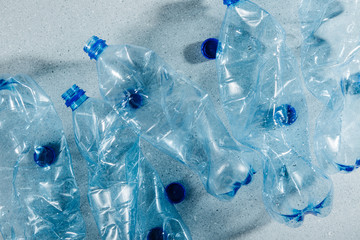Blue single use plastic bottles. Concept of Recycling plastic and ecology. Flat lay, top view