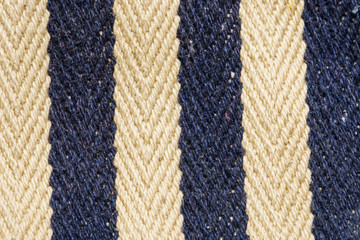 Herringbone tweed background with close up on fabric texture. Striped blue and white material